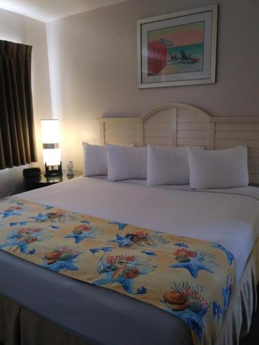 a bedroom with a large bed with a colorful blanket at Beach Place Hotel in Miami Beach