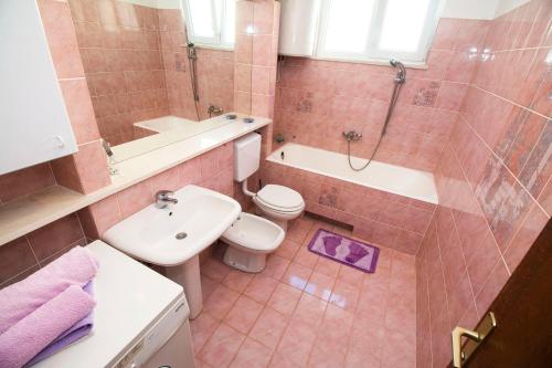 a bathroom with a sink and a toilet and a shower at House Ksenija in Gornje Sitno