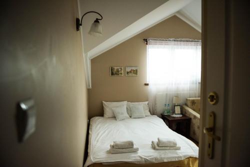 a bedroom with a bed with two towels on it at Lodownia in Szydłowiec