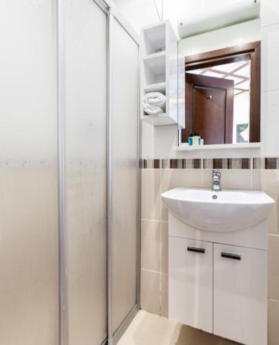 a bathroom with a sink and a shower at Buyukada Comfort OTEL in Buyukada