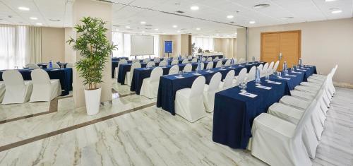a row of tables and chairs in a room at Hesperia Vigo in Vigo
