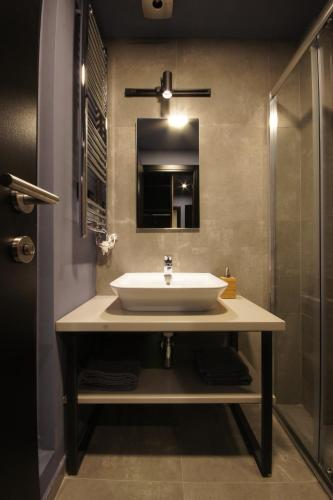 a bathroom with a sink and a mirror at Hotel London B&B in Skopje