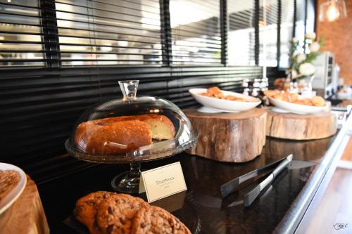 a bakery with bread and cookies on a counter at Le Domaine de Baulieu, Singuliers Hotels in Auch
