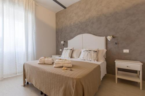 Postel nebo postele na pokoji v ubytování Al Faro Bianco B&B e Residence con parcheggio