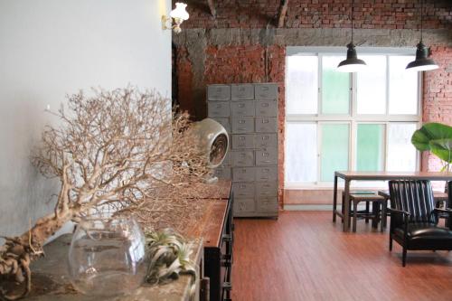 a kitchen with a table and chairs and a window at Tainan MacArthur Homestay in Tainan