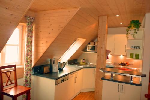 a kitchen in a tiny house with a staircase at Ferienhof Hübner in Bad Berneck im Fichtelgebirge