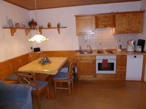 a kitchen with a table and a sink and a stove at Ferienhof Hübner in Bad Berneck im Fichtelgebirge