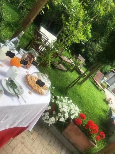 a table with a cake on top of a lawn at Rossella alla Villarella dei Tulipani in Asti