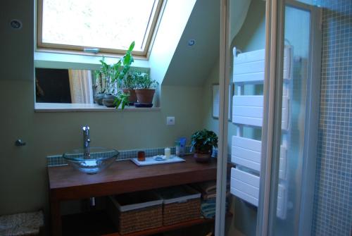 a bathroom with a sink and a window at La Tour in Marcilly-la-Gueurce