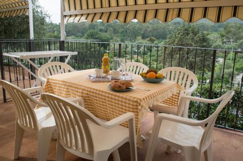 a table with a bowl of fruit on a balcony at Camping Edy in Diano Marina