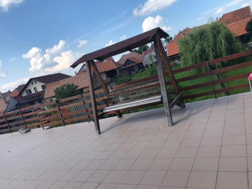 a wooden bench sitting on top of a fence at Casa Sterp in Jina