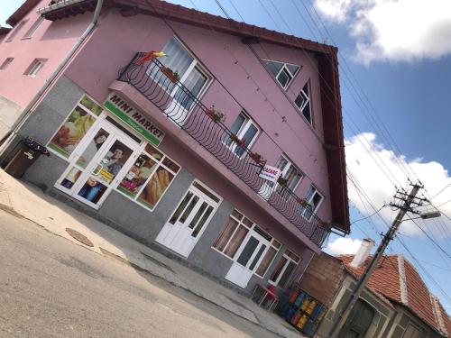 a pink building on the side of a street at Casa Sterp in Jina
