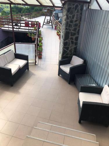 a patio with couches and chairs in a building at Casa Sterp in Jina