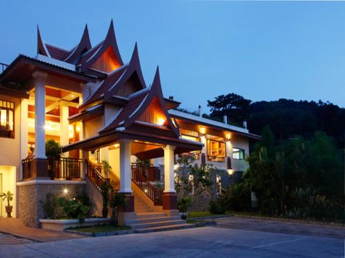 a house with a lit up facade at night at Baan Yuree Resort & Spa - SHA Plus in Patong Beach