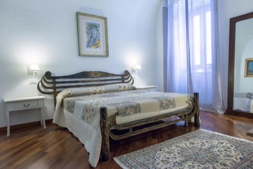 a bedroom with a bed and two tables and a window at Palazzina Porta di Mare in Bisceglie