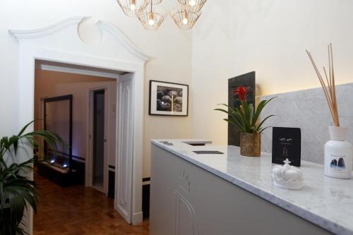 a white kitchen with a counter and a hallway at Il Salotto della Regina in Naples