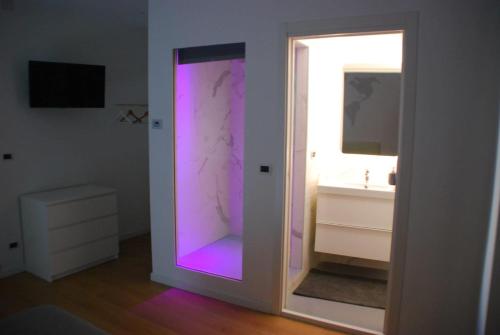 a bathroom with a purple door and a sink at Suite Dreams in Agrigento