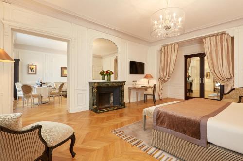 a bedroom with a bed and a fireplace at Majestic Apartments Champs Elysées in Paris
