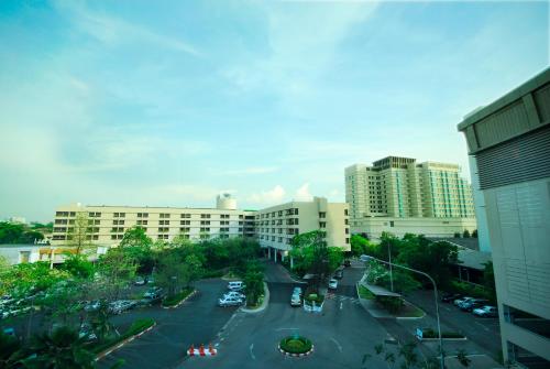 a view of a parking lot in a city with buildings at Rama Gardens Hotel Bangkok in Bangkok