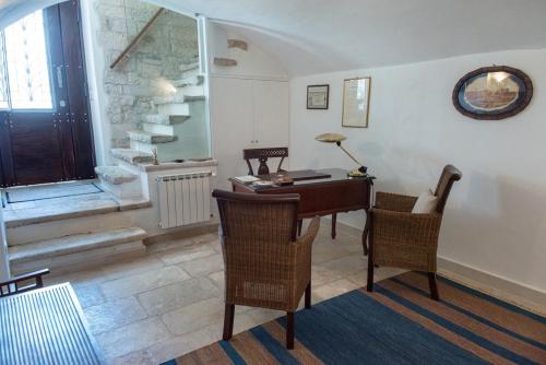 a room with a desk and chairs and a window at Palazzina Porta di Mare in Bisceglie