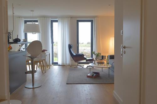 a living room with a kitchen and a table and chairs at Tor zum Meer in Helgoland