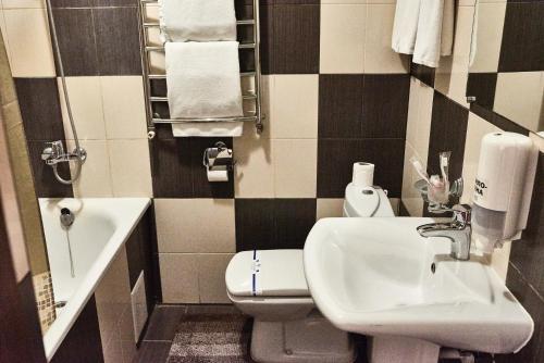 a bathroom with a sink and a toilet at Aivengo Hotel in Rivne