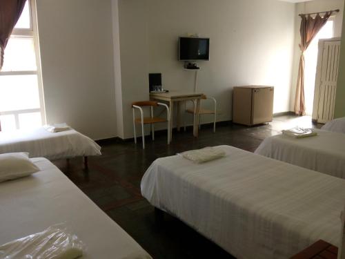 Un pat sau paturi într-o cameră la Trade Hotel Diadema