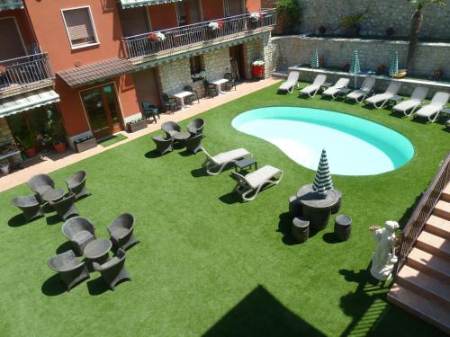 an overhead view of a patio with chairs and a pool at Albergo Casa Este in Brenzone sul Garda