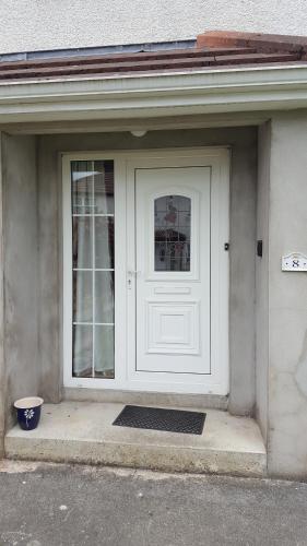 a white door of a house with a window at Laurelbrook Town House in Magherafelt