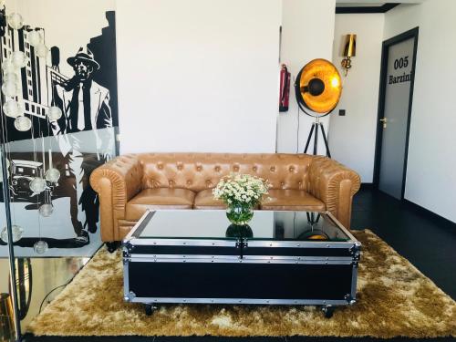 a living room with a couch and a coffee table at Guest House El Padrino in Portomarin