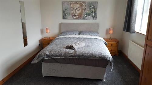 a bedroom with a bed with a pair of shoes on it at Laurelbrook Town House in Magherafelt