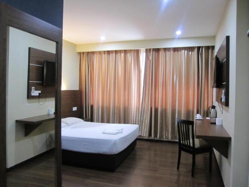 Llit o llits en una habitació de Garden Inn, Penang