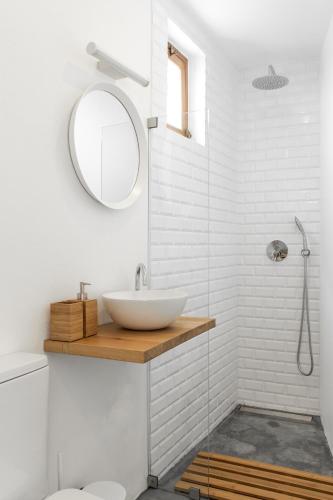 a bathroom with a sink and a mirror at Aljezur Old Town in Aljezur