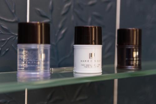 three bottles of cosmetics sitting on a shelf at Il Salotto della Regina in Naples