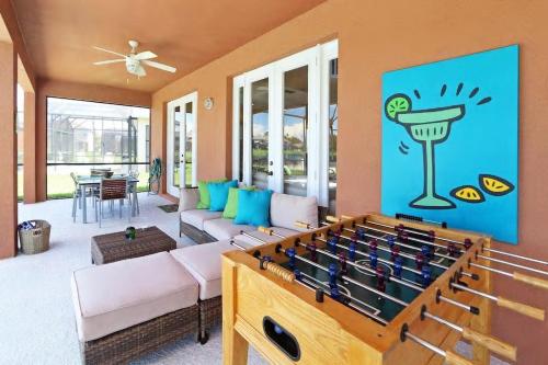 a living room with a large foosball table at Aquamarine Hideaway in Kissimmee