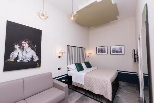 a small bedroom with a bed and a couch at Il Salotto della Regina in Naples