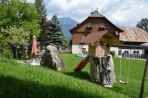a play structure on a tree stump in a yard at Aignerhof in Haus im Ennstal