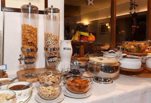 a buffet with bowls of food and other food items at Tortugas B&B in Giarre