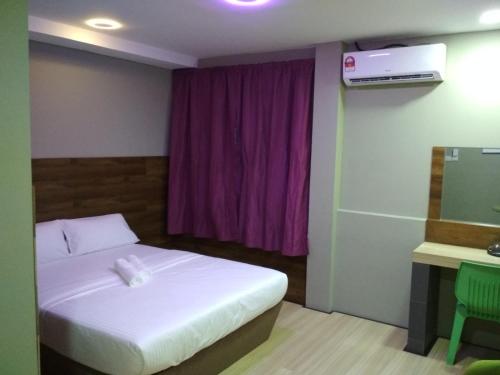 a bedroom with a bed and a purple window at Qing Yun Rest House Gadong, Brunei Darussalam in Bandar Seri Begawan