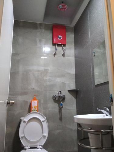 a bathroom with a toilet and a sink at Qing Yun Rest House Gadong, Brunei Darussalam in Bandar Seri Begawan