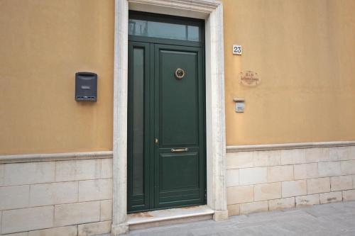 a green door on the side of a building at La Buona Creanza by Jdvacanze in Manduria