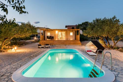 a small pool in front of a tiny house at Authentic Camping Dalmatia in Pirovac