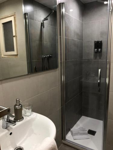 a bathroom with a shower and a sink and a shower at Hotel Sant Jordi in Segur de Calafell