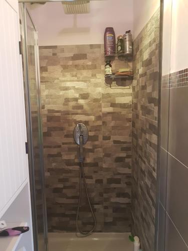 a bathroom with a shower with a glass door at La Casina in Chiusi