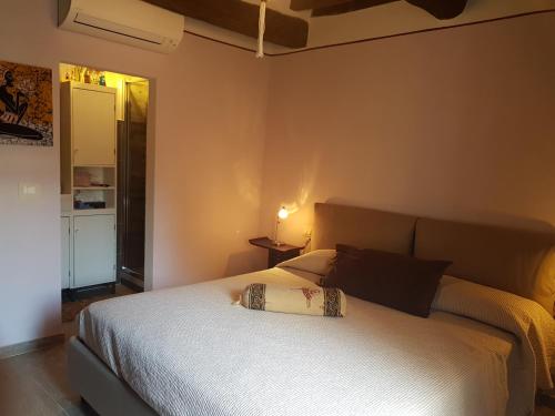 a bedroom with a white bed with a pillow on it at La Casina in Chiusi