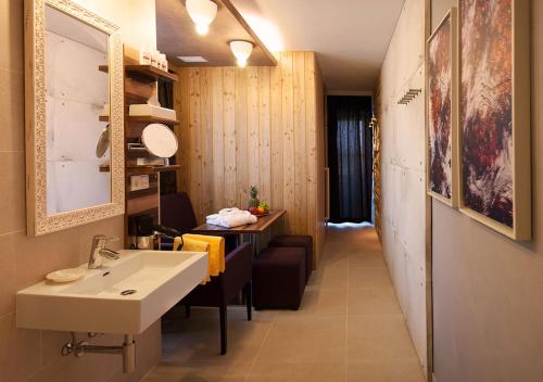 a bathroom with a sink and a table and a counter at Hotel Blumauer in Rainbach im Mühlkreis