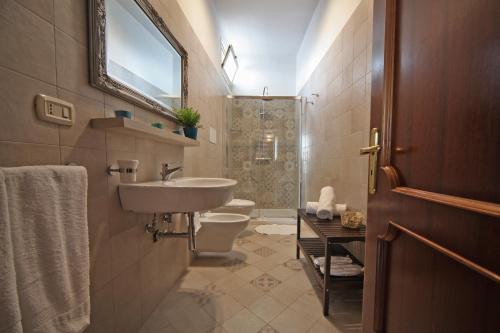 a bathroom with a sink and a toilet and a shower at La Buona Creanza by Jdvacanze in Manduria