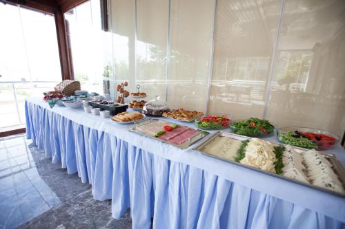 a long table with food on top at Buyukada Comfort OTEL in Buyukada