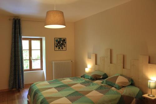 a bedroom with a bed and a window at gîte "la percée des lacs" in Châtillon