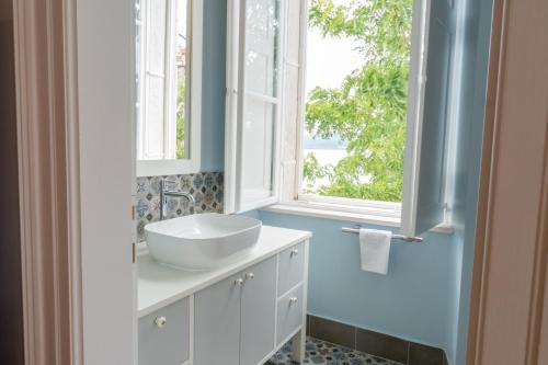 a bathroom with a sink and a window at Beachfront 4-bedroom villa Sea Wave in Orebic, Croatia in Orebić